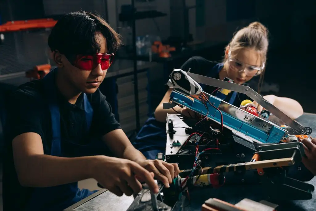 Electric Engineers working on a robot for battle
